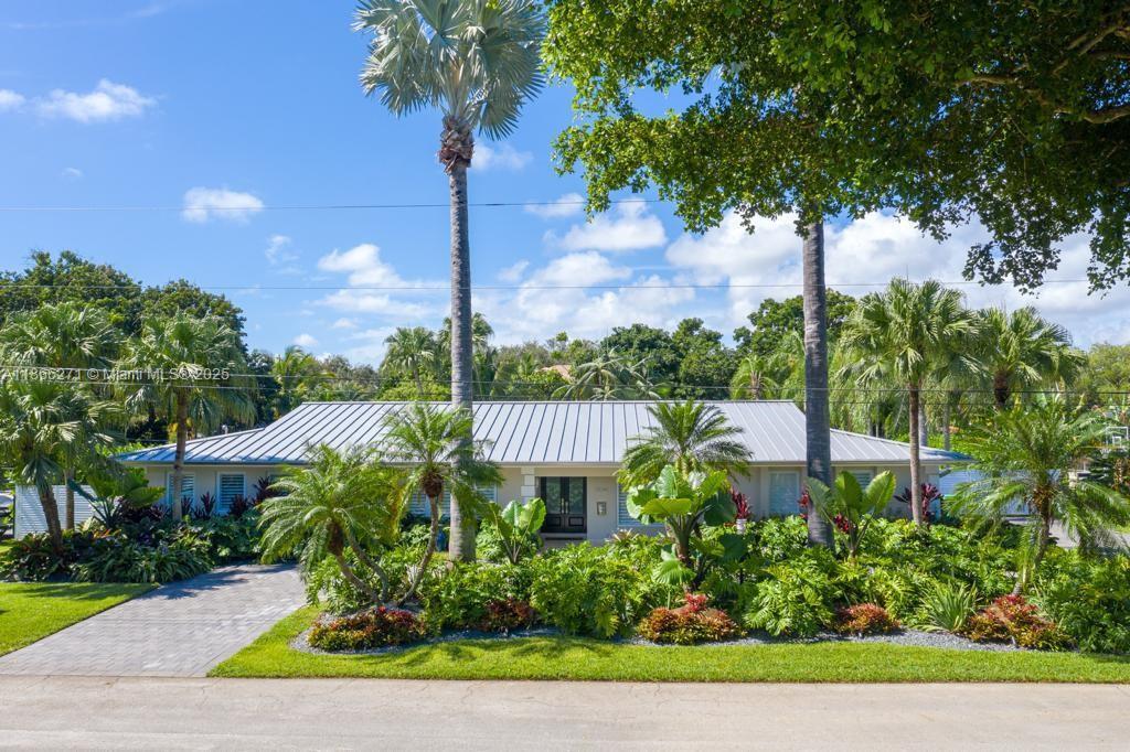 Experience refined waterfront living in the heart of Pinecrest. This fully renovated canal-front home offers elegance and comfort in a family friendly Palmetto Island neighborhood near top private schools. Inside you will find leather-finished marble floors, plantation shutters, and impact windows and doors. The kitchen features custom cabinetry and Thermador appliances, including double ovens, warming drawer, and wine chillers. A butler's pantry with 300-bottle wine fridge and built-in TV wall unit with mini bar making entertaining effortless. Step outside to brand new heated/chilled pool with deck jets and limestone deck. The outdoor kitchen is fully equipped with 60-inch grill, kegerator, ice maker, dishwasher and dual sinks. Intergrated speakers, security cameras, Nest ring & more.