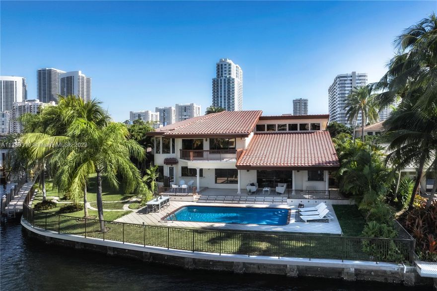 Welcome to a one of a kind waterfront POINT LOT estate in the exclusive gated community of Golden Isles located in the heart of Hallandale Beach. This property features an oversized 16.100 SF of land and over 180 FT of water frontage! The residence consists of 5,200 SF of living space with 4 Bedrooms, 4 Full bathrooms, several family rooms, wet bar, 2 car garage and a 100 FT dock for Yacht enthusiast. This unique property allows you to park your yacht over 100 FT without blocking your western sunset views!! No fixed bridges, open sea in 15 minutes!