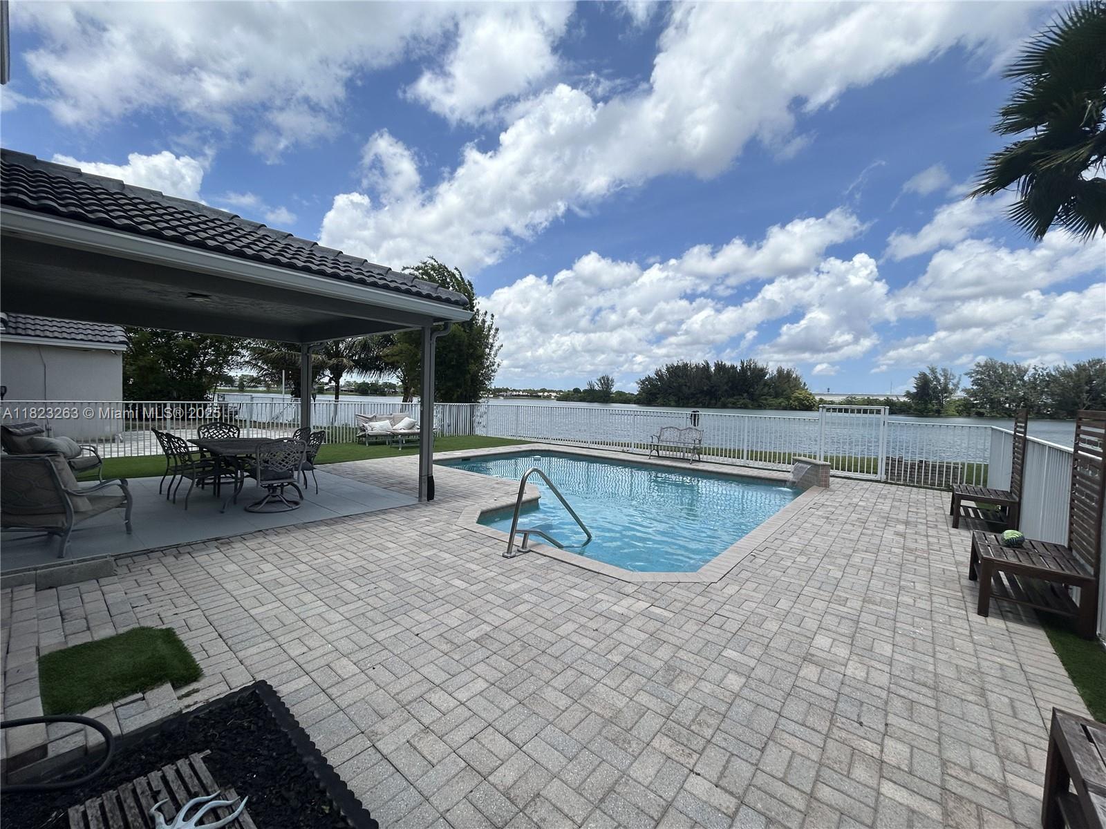 Beautiful 3 bed, 2 bath lakefront home in a quiet cul-de-sac with no front neighbors. Enjoy serene water views from your fenced backyard, featuring a covered terrace and sparkling pool—perfect for relaxing or entertaining. Open-concept layout with concrete floors downstairs and laminate flooring upstairs. Spacious 2-car garage. This home offers the perfect blend of comfort, privacy, and outdoor living. 2 month deposit first month rent. Proof of income, credit and background check for adults, no exceptions. Monthly price includes, pool mainteance, lawn mainteance and fumigation.