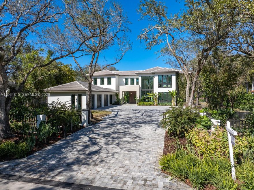 Experience luxury living at The Sanctuary at Galloway Glen, a private modern estate completed in February 2026. Set on an impressive 36,155 SF lot that stretches an entire block with access from both 99th and 100th street. This newly built estate offers exceptional privacy in one of Miami’s most peaceful and hidden neighborhoods. Total square footage is 6,100 SF, showcasing a thoughtfully designed layout with 5 spacious bedrooms—each with a walk-in closet—and 7 elegantly finished bathrooms. Floor-to-ceiling impact windows fill the interiors with natural light and create a seamless connection to the outdoors. A gourmet chef’s kitchen anchors the main living space, appointed with top-tier gas appliances and a spacious walk-in pantry. Extra large porcelain flooring and refined neutral finishes enhance the home’s modern aesthetic. Additional features include a 3-car garage, whole home gas generator, premium flat-tile roof, integrated indoor and outdoor speakers, alarm and security camera for peace of mind. Outside, a resort-style pool with built in hot tub, in pool lounge and expansive outdoor areas offer a perfect setting for relaxation and entertaining. This rare offering combines architectural elegance, modern amenities, and a premier location near top schools, marinas, parks and luxury shopping—an exceptional opportunity to own a true statement home in Galloway Glen.