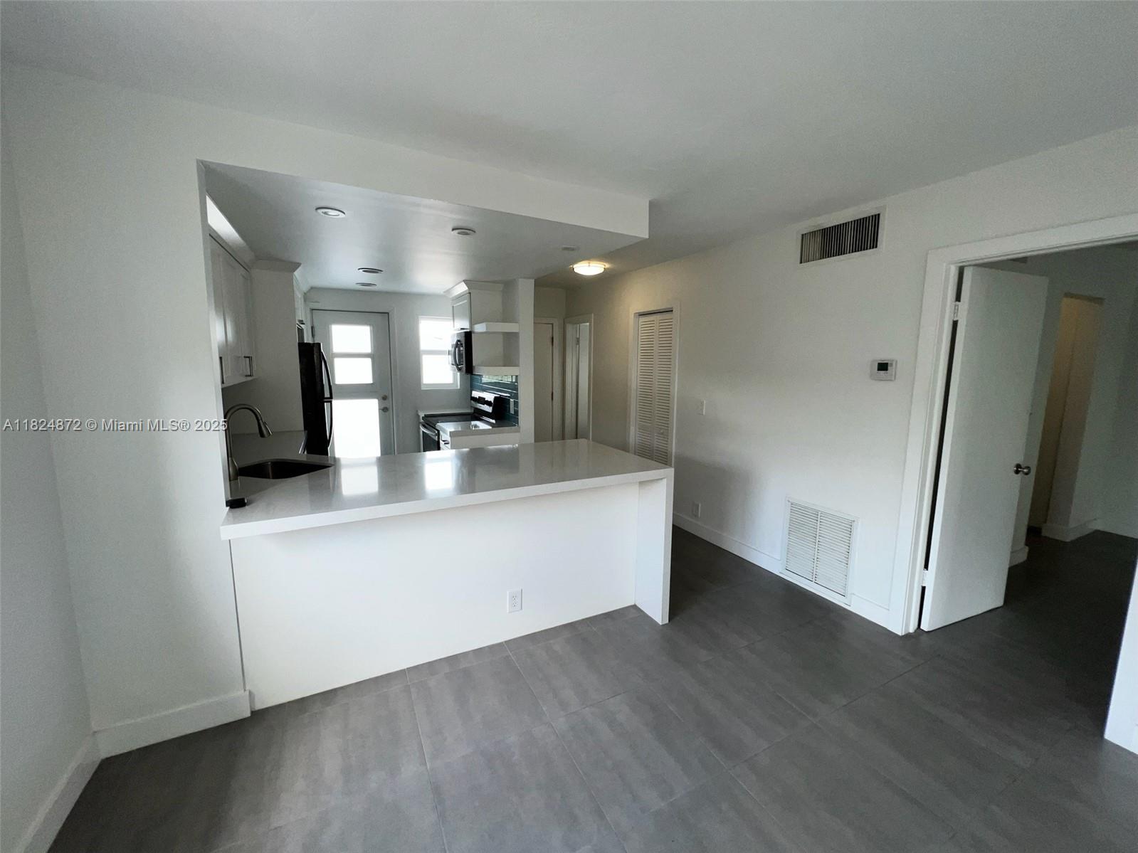 Corner unit on the top floor with an enclosed balcony, impact windows, tile floors and walking distance to the Key Biscayne Beach, with private access.