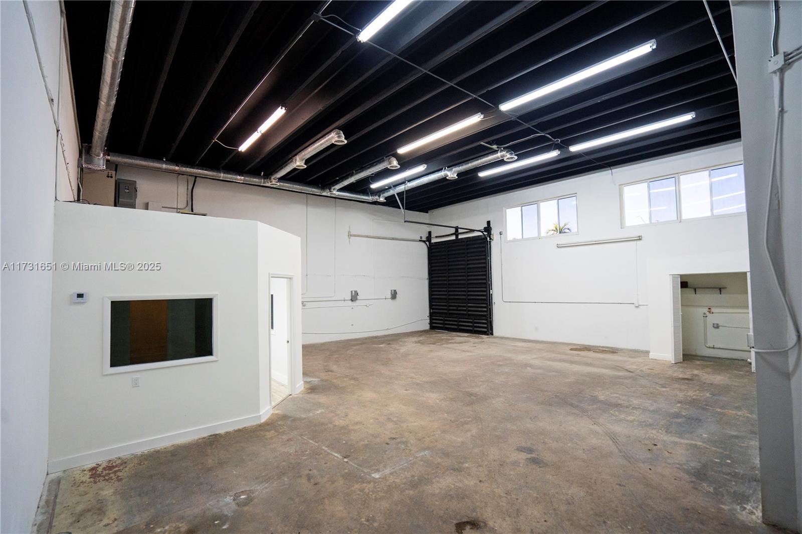 Corner warehouse unit with rear yard, fully air-conditioned warehouse, 3-phase electric, and a small office. High ceilings with a concrete twin-t roof.