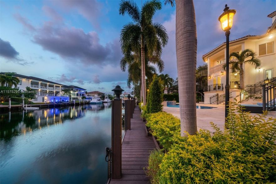 Gables by the Sea direct ocean access luxury custom built home on high elevation with 100' direct ocean access on deep, wide quiet waterway canal. 5564 SF estate boasts 6bd 4.5ba w/double height soaring ceilings showcasing tropical waterway and garden views. Elegant formal living room overlooking pool & spa. Spacious dining room & expansive kitchen opens to family room w/convenient wet bar, breakfast area. Immediate access to your privately docked ocean cruiser. 100' epay wood dock, pilings, 15K lb boat lift, 50amp elect tower.  Bonus captain’s rooms to neatly house all your nautical gear, freezer, etc. And bonus basement AC room makes a great wine cellar! Bring your yacht home, enjoy sunsets from a covered veranda, summer kitchen & refreshing htd pool+spa. Garage w/lift for 3 cars, EVC.