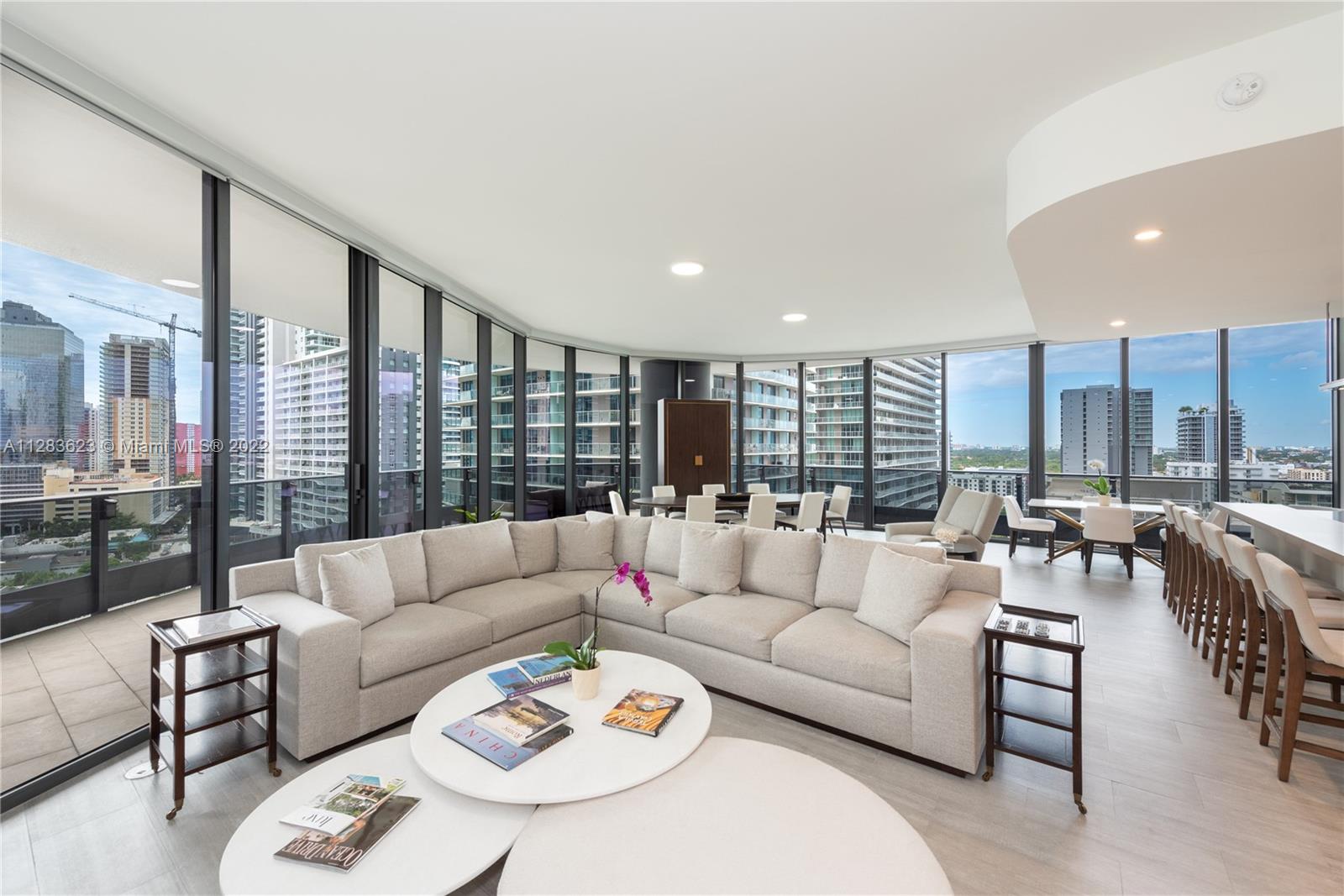 Two-story, 18th floor townhouse in the SW corner line in Brickell Flatiron offering dazzling city and sunset views. This unique luxe residence comprises 5,251-sf of total indoor and outdoor space, including 5 beds, 5.5 baths, expansive living areas, 2 wraparound terraces, and outstandingly, 5 parking spaces and a 23’ x 9’ AC storage unit. Wraparound walls of glass enclose the corner 18-floor living room and Snaidero kitchen, and the corner 17-floor master suite. Smart control system, automated shades and blackouts in all beds, 10-to-12 feet ceilings throughout, and many walk-in closets complete this unit. Extravagant amenities, 2 pools on the 64th and 18th floor, rooftop spa and fitness center, movie theater, clubroom, playground, lounge room. Located in the heart of urban Brickell!