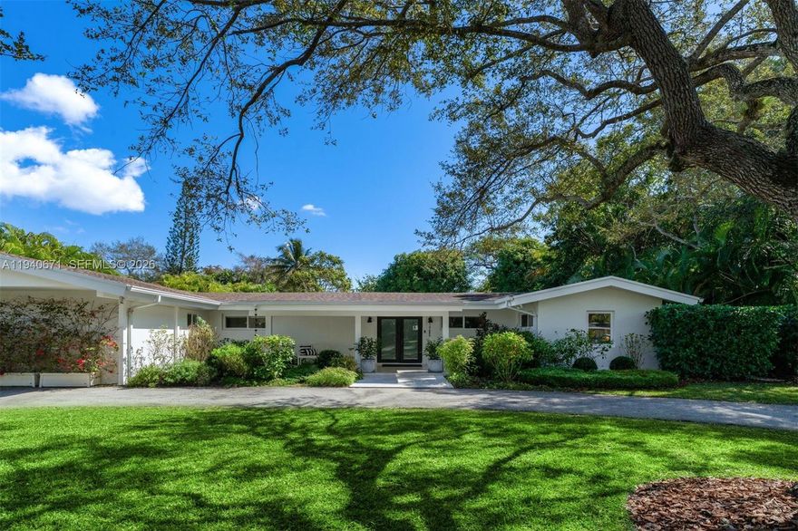 Set on a spacious half acre lot in Pinecrest, this light-filled 5BD 3BA single-story home offers privacy, comfort and seamless indoor-outdoor areas for play and relaxation. The European-enhanced kitchen is elegant and smart, featuring shaker-style wood cabinets with satin brass pulls & a white marble island opening to the family room. The wall of French doors and windows offers endless views of the pool & spacious gardens. The desirable split floor plan with porcelain flooring provides both space & privacy. The primary suite is a private retreat featuring a large walk-in closet, a well-appointed en-suite bath with walk-in shower and dual vanity sinks and access to the pool and veranda. Four additional split-plan bedrooms with 2 full baths offer comfortable accommodations for family and guests. There’s a separate laundry room and a den, suitable as a private office. Outdoors, the expansive, fenced backyard is framed by mature landscaping, including mango, avocado & lemon trees. The spacious veranda with full summer kitchen is ideal for gatherings and alfresco dining alongside the sparkling saline pool & natural coral stone patio. The separate pergola and hot tub provide additional areas to unwind and relax. Some of the highlights include a 2014 roof, 2015 impact doors and windows throughout, a large circular driveway with ample parking, and a storage shed. Perfectly set on a quiet interior Pinecrest tree-lined street close to neighborhood parks, shoppes and top-rated schools.