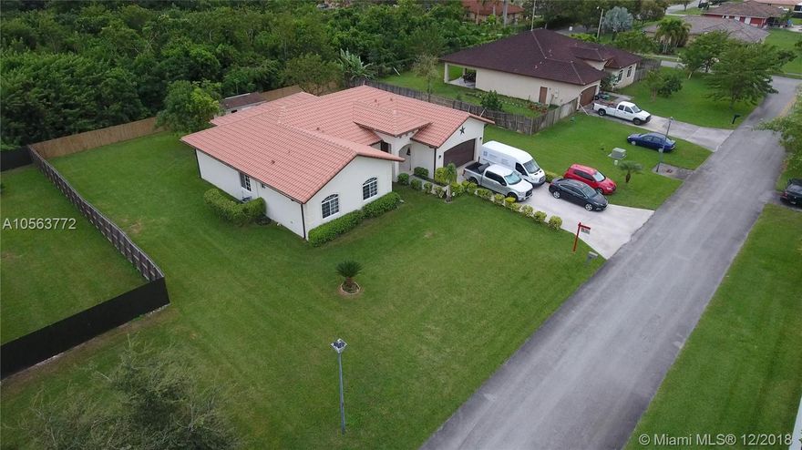 JUST SHY OF A BUILDERS HALF ACRE WITH NO ASSOCIATION... SITS A 4/3 SPLIT PLAN WITH VAULTED CEILINGS. SHE BACKS UP TO A HARDWOOD HAMMOCK THAT OFFERS TREMENDOUS  PRIVACY WITH PLENTY OF ROOM FOR A POOL OR GARDEN.THE MASTER IS OVER SIZED AND OPENS TO THE COVERED PATIO. THE KITCHEN HAS A BREAKFAST NOOK AND IS ADJACENT TO THE FAMILY ROOM. ITS A TREMENDOUS FLOOR PLAN WITH A 2 CAR GARAGE, LAUNDRY ROOM W SINK, JACK N JILL, UNDER GROUND UTILITIES, STREET LIGHTS ,CLOSE TO BUS WAY, WORSHIP, SCHOOLS AND SHOPPING.......NORTH FRONTAGE ALLOWS GREAT BREEZES AND MAX USAGE..