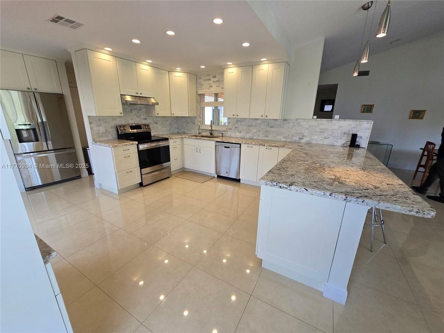 Please note SF is approx 400 sf more than listed in tax records. Beautifully furnished & renovated 2 bed, 2 bath home. New impact windows. Golf Course views in Beautiful Indian Spring Country Club.  Open and updated white shaker, custom kitchen with Stainless Steel  appliances & quartz countertops. Enjoy high end quartz tile floors through out this beautiful home. The open floor plan is great for entertaining and flows through out. A Pet friendly community. Impressive brick pavers wrap around the patio, driveway and 2 separate screened patios. Master bedroom suite has large walk in closet. Fabulous updated baths. AC 2018, Hot water heater 2017. This is a gated, pet friendly community within Indian Spring where membership in the club is optional. This is what you are looking for!