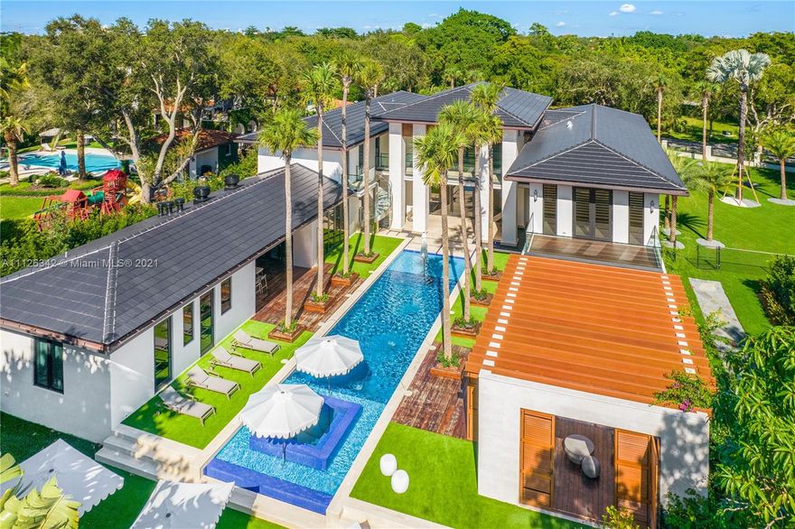 Introducing the extraordinary "Aqua Azure" a brand new, exceptionally designed estate situated on a tree-lined street in the heart of Pinecrest. Upon entering this stunning home, one is greeted by serene water features, dramatic volume ceilings and floor to ceiling impact glass that provides ample natural light to the interior. This sensational resort-style home offers superior features: savant smart system, ultra modern and sophisticated kitchen, 2 wine cellars/humidor, state of the art home theater, office, elevator, full house generator, 3 car garage with lift, fully equipped guest house, fabulous outdoor kitchen with adjacent fire pit, a master suite with its own private outdoor jacuzzi and lounging area, and a 75ft heated infinity pool. A truly unparalleled design.