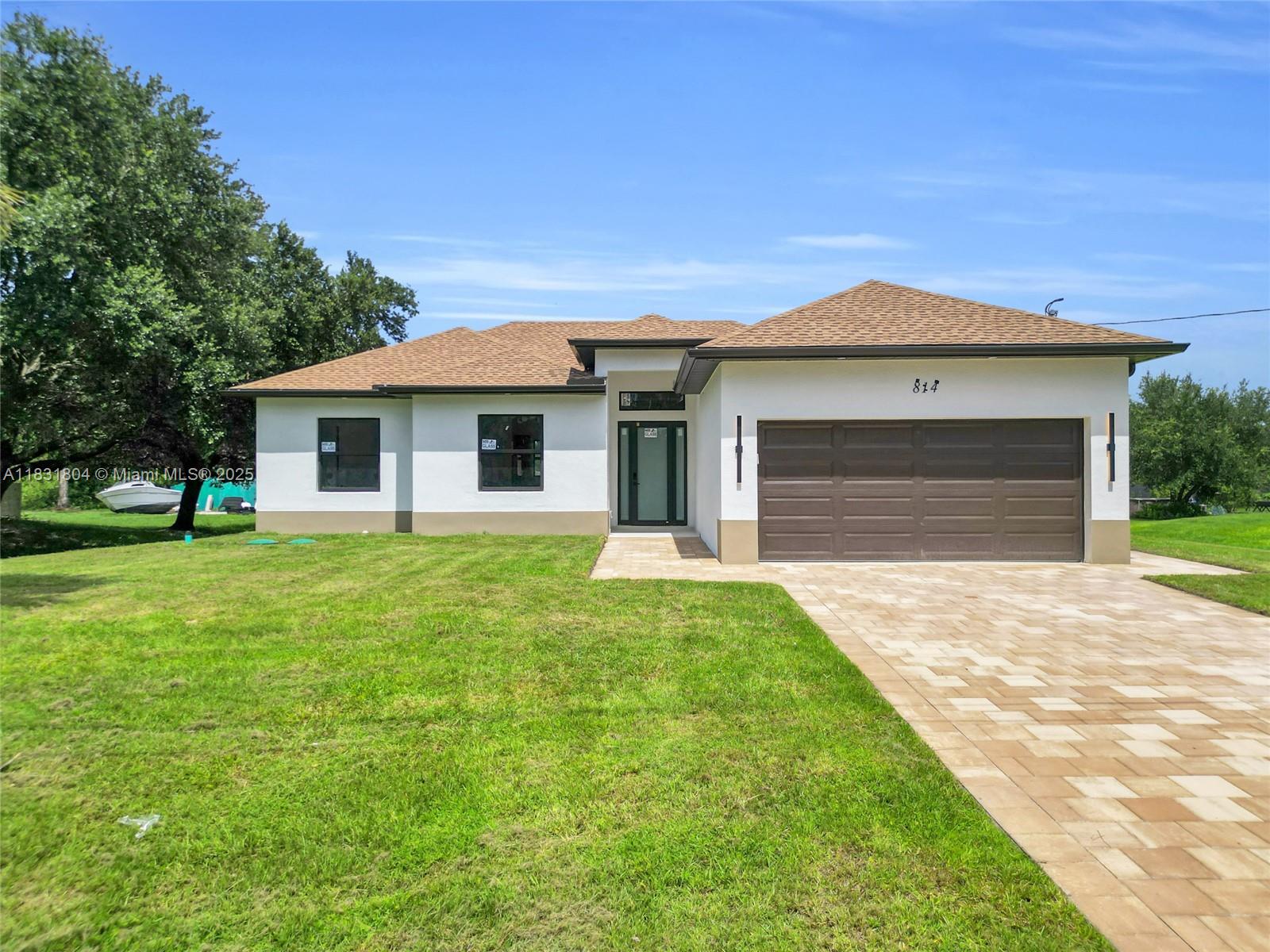 The seller is offering $10,000 in concessions toward buyer closing costs and prepaid items—an amazing opportunity! This incredible property in Lehigh Acres sits on a spacious half-acre lot in a quiet, family-friendly neighborhood. It features high-end finishes, impact windows, sleek tile throughout, and 10-ft ceilings. The kitchen includes premium LG appliances, while the laundry room offers a washer, dryer, and utility tub. You'll love the beautiful cabinets and closets in each bedroom, the large lanai, and the epoxy-finished garage. The paver driveway and side entrance make it easy to park trucks, boats, or even build your own RV pad. With plenty of space for a future pool, this home offers luxury, comfort, and endless potential.