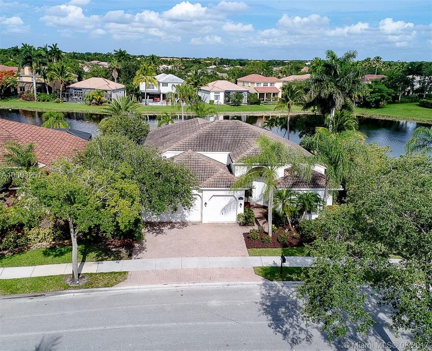 If you are looking for privacy, relaxation and entertainment in one of the most sought after neighborhoods in Weston this is your house. Open floor plan,vaulted ceilings, plantation shutters with a oversized lakefront lot and a salt water system pool and screened patio. Water views from almost every room. Upgraded SS appliances granite counter top in kitchen and new washer and dryer. Plantation shutters  in all the windows .Hurricane shutters. Two a/c zones. 5 bedrooms 3 bathrooms and 3 car garage. Tile in all main living areas and wood floors in all bedrooms.