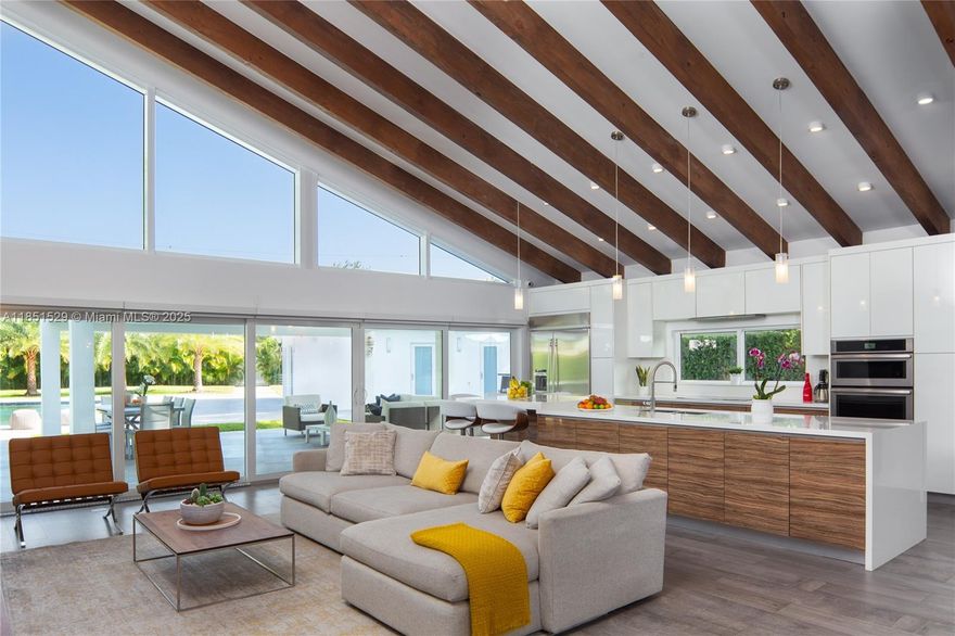 Miami Shores Midcentury Modern Style Oasis: Situated on a 23,000 Sq FT lot, this unique and secluded expansive resort style home boasts an outdoor kitchen/bar, independent fully equipped cabana overlooking a beautiful salt water pool with additional green space to build a tennis court. The quintessential family and entertainment home to enjoy all year round. Stunning residence with astounding 1,200 Sq FT great room, 18' ceiling, tons of light and modern high impact windows. Extraordinary home for lovers of design, light and ample space. Not in the flood zone. Underground electrical and quality new construction allow enjoyment of all seasons including worry free hurricane season. Open concept gourmet kitchen with tons of storage and custom cabinetry. Porcelain floors inside and out.