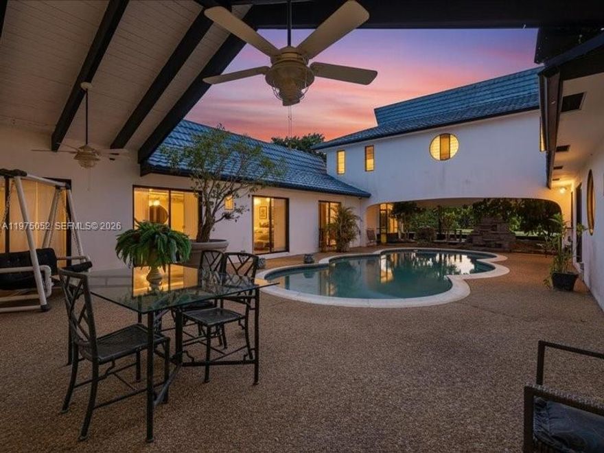 Offered for the first time since the 1970s, this rare generational estate in Eldorado Estates in Plantation is an Asian-influenced masterpiece of architecture and Japanese design, with a layout perfectly suited for multigenerational living. This expansive 5BD/4BA home spans OVER 4,400 SF of single-level living on a prime corner half-acre+ lot and showcases intentional horseshoe flow surrounding an intimate courtyard pool, creating seamless indoor-outdoor harmony. Recognized as a true architectural piece, the home was even selected for HGTV’s America’s Most Unique Homes, though declined due to timing. From the imported New Zealand blue metal tile forever roof to Zen waterfalls, gardens, shoji doors, a private dining room and office, sunken bar, and dramatic stove pipe fireplace, every detail reflects thoughtful craftsmanship and timeless vision. Walls of glass, soaring ceilings, and expansive living spaces celebrate light, privacy, and architectural integrity, offering flexibility for extended family, creative workspaces, or a future trophy estate. Held by 1 family for over 5 decades, this is not a trend or a flip but a legacy property with provenance, presence, and the rare opportunity to preserve, elevate, or reimagine a paradigmatic showpiece in one of Plantation’s most established enclaves.