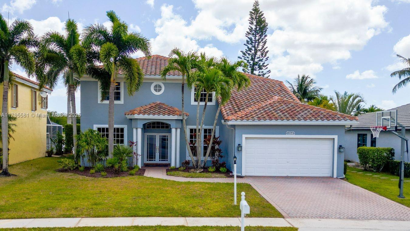 Experience luxurious lakefront living in this great home located in the highly desirable West Boca community of Boca Winds / Waterways. Enjoy expansive lake views from an open-concept layout elegant tile and rich wood flooring. Major recent upgrades, including a new roof (2022), new hurricane impact windows/doors/garage door (2023), 2 new A/C units (2022), new water heater (2024), and new washer/dryer (2024).The spacious kitchen features stainless steel appliances, ample cabinets, and generous counter space. Conveniently located first-floor bedroom and half bathroom. Covered patio and lush backyard oasis with tranquil lake views, ideal for relaxing or hosting gatherings. The community offers 2 community pools, playgrounds, tennis, and basketball courts. A+ rated school district.
