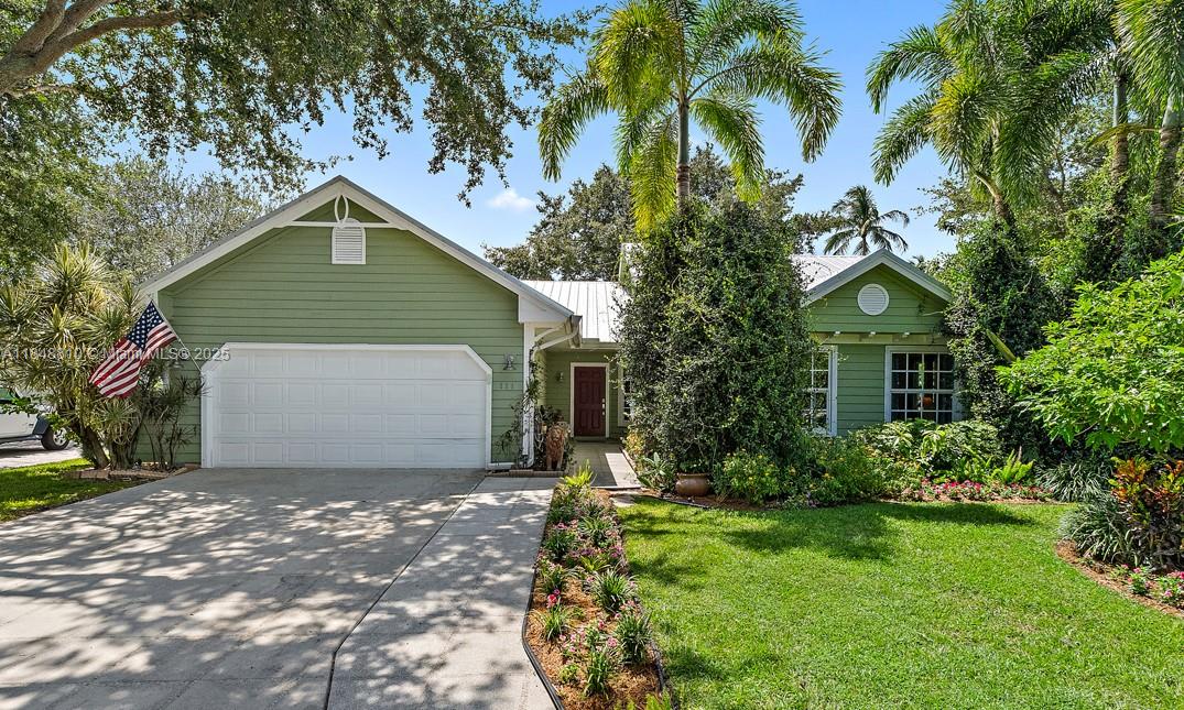 This Key West style home is yours to step into! Single story, split floorplan, 3 bedroom, 2 bath, enclosed family room/porch with new metal roof, impact windows & doors throughout are just the beginning of upgrades. The premium cul de sac location sits on a professionally designed botanical garden with vibrant flowering paths that will offer privacy and tranquility. Enjoy the new baths, upgraded kitchen with quartz counters, white cabinetry and casual breakfast bar. Newer HVAC, appliances, ceiling fans, french doors, wood burning fireplace, additional storage space and freshly painted throughout. Enjoy the laid-back island charm with modern comforts you deserve. Minutes to beaches, schools, medical facilities, shopping, I-95, Fl. Turnpike and 30 minutes to the airport. A true gem!