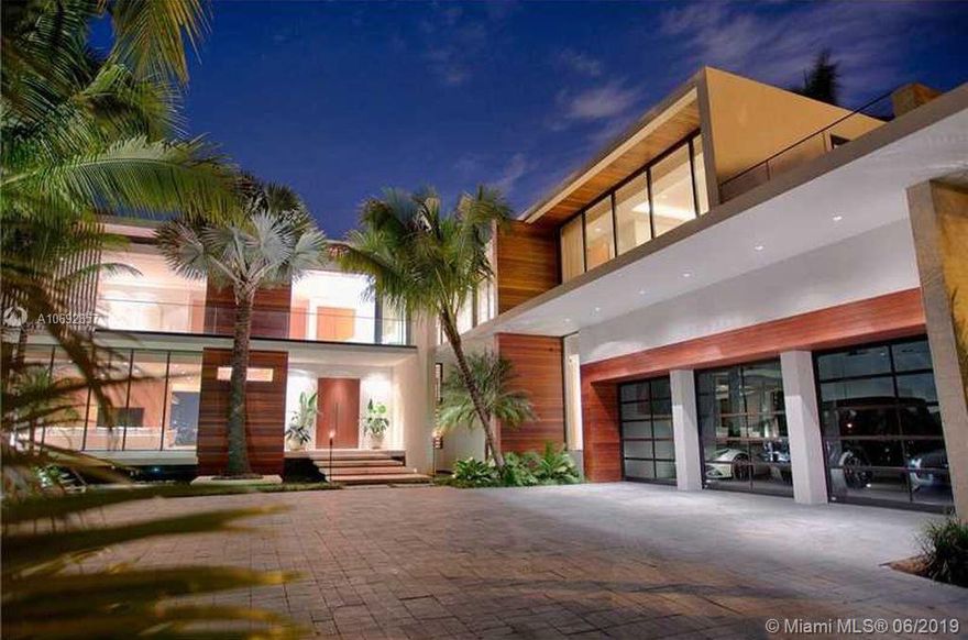 Magnificent modern waterfront estate located on prestigious guard-gated Hibiscus Island. Impeccably designed by renowned architect Ralph Choeff. Situated on a 19,466 SF pie shaped lot boasting 10,503 SF of living space plus 145 WF with unobstructed southwest facing stunning Downtown & cruise ship views. Luxurious amenities include: chef's kitchen, butler's pantry, wet bar, home theater, wine cellar, elevator, 3 car garage, lap pool w/ jacuzzi plus outdoor shower, summer kitchen, beach area w/ firepit, 3 car garage, new seawall & private dock + secluded rooftop w/ kitchen, jacuzzi & outdoor shower.