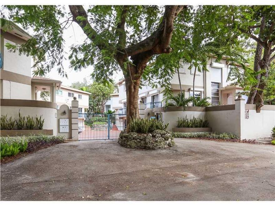 Situated in a gated community of 7 townhomes, this rarely available hidden gem offers location on a cul-de-sac, security, parking & a completely updated infra-structure with only $100/Mo HOA. Located in central Coconut Grove, two blocks from shops & schoo ls, this townhouse has an open floor plan, hot tub & patio plus a 2 car garage. Built in 1994, it features a new roof, attic insulation & gutters, water heater, washer/dryer, air conditioner, an updated kitchen and master bath.