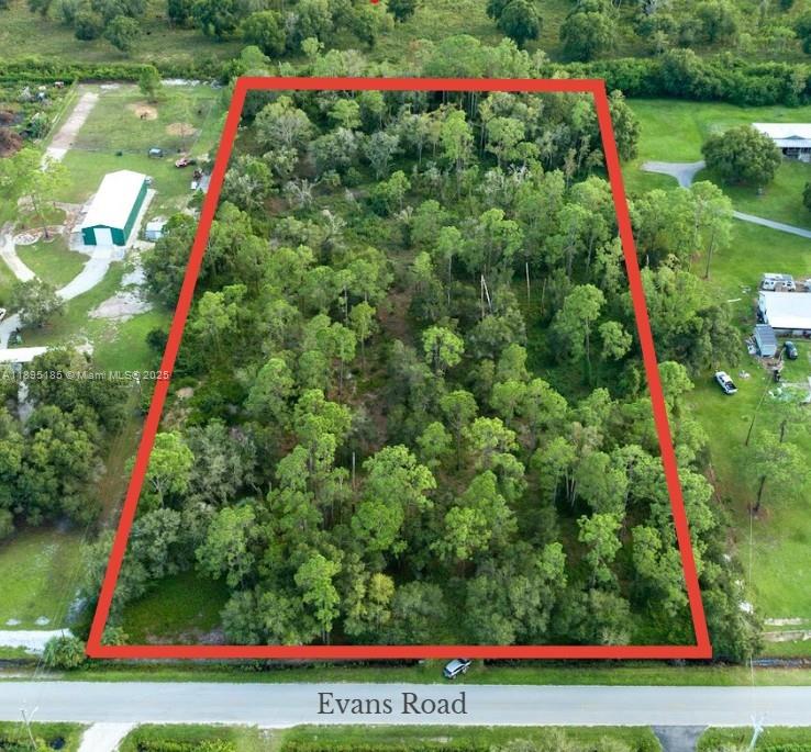 Beautiful 4.5 -Acre Tract Near LaBelle, FL. Stunning 4.5-Acre parcel on a paved road near the fast-growing rural town of LaBelle, just 30 minutes from Fort Myers. Land is partially cleared with many mature trees for beauty and privacy, partially fenced with double gates, and features a scenic stocked pond with a center island. Perfect for kids, animals, and country living. Property may be split through Hendry County for family compound or future resale. Area allows site-built, modular, or mobile homes, and outbuildings are easily permitted.