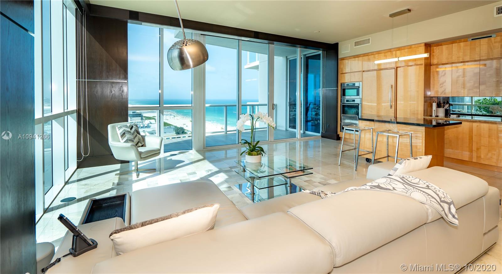 Extremely rare & unique (only 4) with 1000+ SFT spread over 3 covered terraces with sweeping views of the ocean, coastline, SoBe, Bay & Brickell. YES, you get the best of all worlds, from breakfast sunrise to romantic sunsets! Spacious DOUBLE corner unit, tons of 10 ft floor to ceiling impact windows, desirable split ensuite master bedrooms each with a private balcony. 92 inch projection TV with surround sound in living & master. Chef's kitchen w Subzero, Miele Appls. Marble & bamboo wood flrs, 2 wine coolers. Private fingerprint elevator direct to your unit. Over 12 lush acres of 5-star amenities incl 24-hour security, 3 tennis courts, private beach pavilion, 2 lagoon style pools, 23K SFT fitness, spa & lap pool. Turn-key furniture included, simply unpack & enjoy! Space for home office.