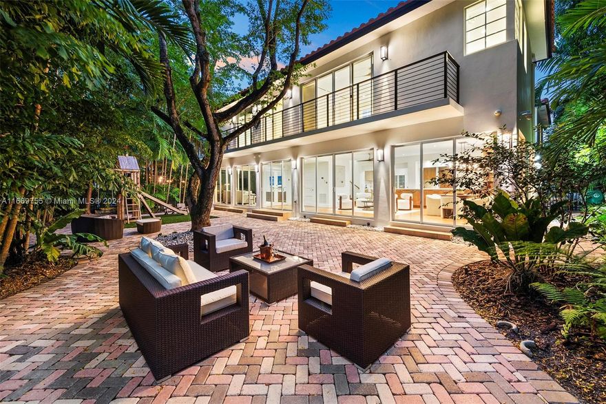 Chic, tastefully renovated residence in guard-gated Morningside. Enjoy the charm of a Mediterranean home with a modern feel! Nestled on a lushly landscaped 8,250SF lot w/ a grand driveway of Chicago brick, courtyard with fountain, mature trees, & plenty of parking. Boasting completely updated interiors, multiple living spaces, impact windows/doors, kitchen w/ pot filler & bar, gym/office & a fantastic floor-plan w/ 3 bedrooms up, 2 down, & 2 primary suites. Relax in the serene & private backyard w/ seating areas & room for pool. NOT IN A FLOOD ZONE. Mins to 40+ acre park w/ tennis & basketball courts, football field, walking trails, picnic & bbq areas, pool, boat ramps, & kayak rentals. Close to top schools: Cushman, & Miami Country Day. 15 mins to MIA Airport!