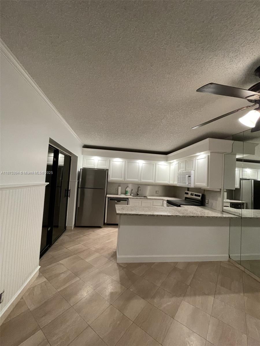 This charming townhouse located at 143 Ocean Cove Dr, Jupiter, FL is next to Carlin Park and approximately 1300 yards (0.75 miles ) from the beach. With 2 bedrooms, 2 bathrooms, and 1 half bathroom, this home boasts a finished area of 1,288 sq.ft. The property has a private, fenced in courtyard and faces away from the street, to provide extra privacy. The property features a well-maintained exterior, a large community swimming pool, two assigned parking spaces and a spacious interior with plenty of natural light. Don't miss the opportunity to make this townhouse your new home in the Jupiter area.
