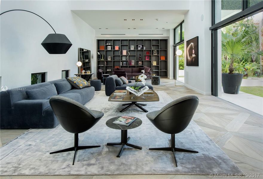 Ready for immediate enjoyment. Contemporary oasis w/ 11,500 sf of curated living & open bay sunsets. The sleek interior exudes unprecedented level of craftsmanship. Details include suede walls, ultra-luxury Italian furniture & Hermes decor for a turn-key living experience in Haute style. 100-foot mosaic pool w/ infiniti jacuzzi, BBQ pavilion, gym, massage lounge and private spa. 100 ft of expansive waterfront with dock & boat lift. Elevator to a massive rooftop garden w/ breathtaking Downtown Miami views.