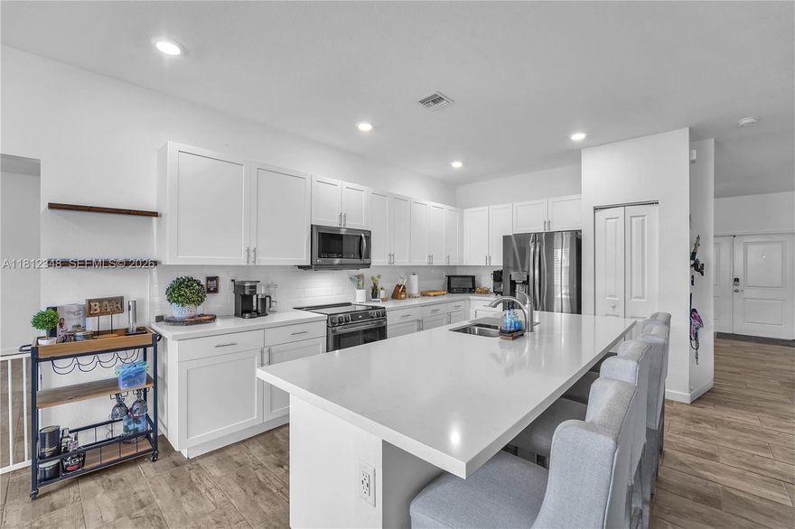 Stunning 4BD/3BA corner-lot home built in 2018 with only one side neighbor for added privacy! Features an open-concept layout filled with natural light, a modern kitchen with stainless steel appliances and spacious island, plus walk-in closets in every room. Includes a private guest suite with full bath—ideal for extended family or rental income potential. 2-car garage, beautifully landscaped, and move-in ready. Prime location near US-1, Turnpike, and Berry Farms!