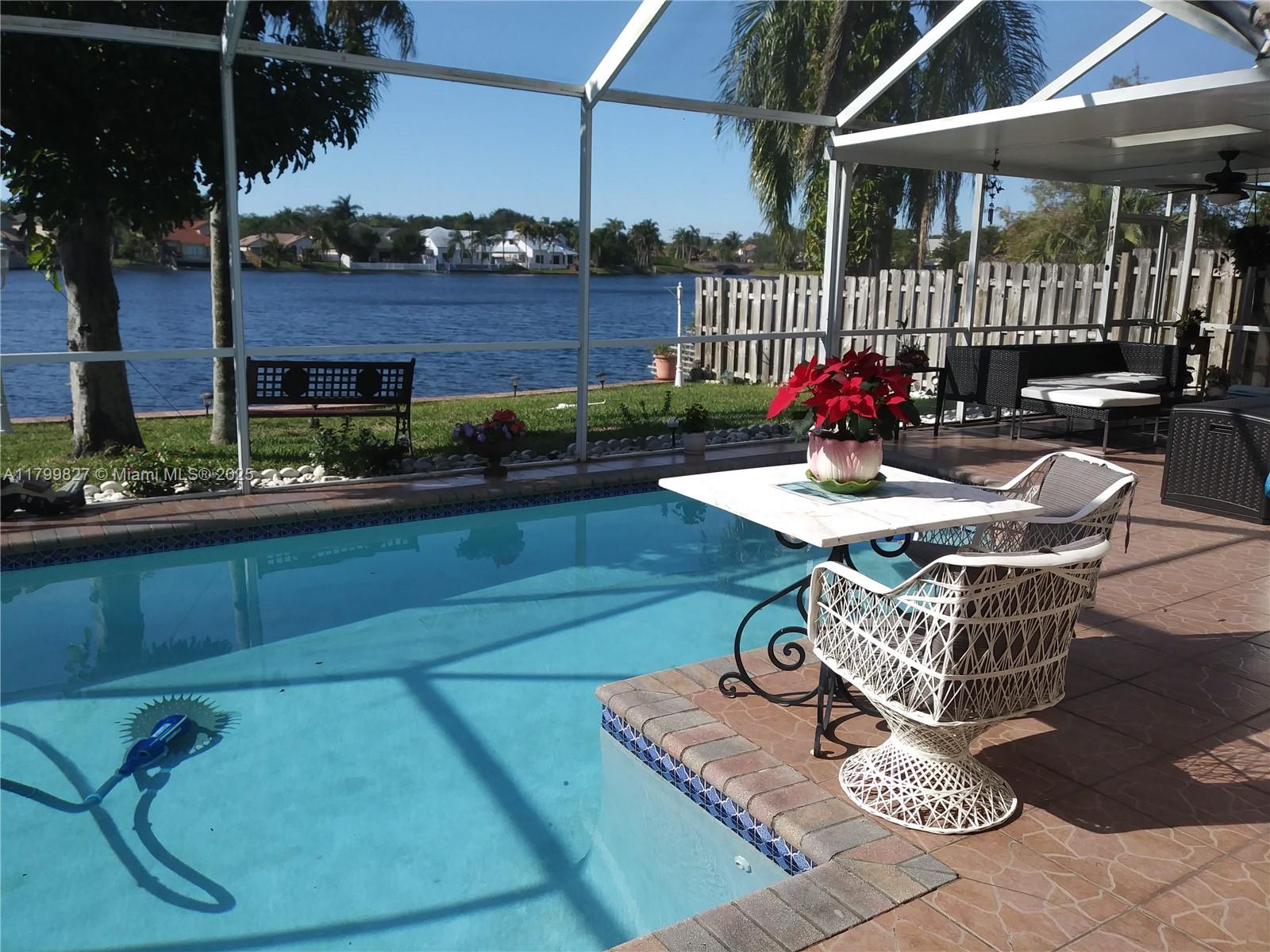 RARELY available! WIDE OPEN LAKEFRONT home nestled in the desirable gated Reflections at Rock Creek. BARREL Tile Roof 2024. Rheem 5 Ton A/C Jan 2023.Featuring high ceilings and an abundance of natural light. The updated kitchen features granite countertops, stainless-steel appliances, and ample storage space. This home offers lovely direct water views with 50 feet seawall and breathtaking sunset views from this navigable lake. The tropical private backyard features an oversize screened saltwater system pool with heater for all year enjoyment. Also, yard offers a cover patio, creating the perfect space for relaxation and outdoor entertainment. Neighborhood offers access to local amenities and organized festivities. Great neighbors. Top-rated schools. Seller motivated! Very easy to show.