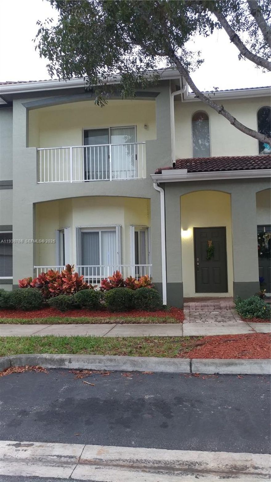 Two Story Townhouse with garage and balcony, parking in rear and front of building. Association fee includes insurance for building exterior, internet and media, alarm service, gated community, use of pool and playground.