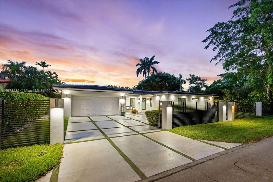 Located on a serene and private drive in South Coral Gables, this beautifully finished home features a large entertaining space with living, dining and family rooms connecting seamlessly to the covered patio w/ summer kitchen, all overlooking the expansive back yard that features an easy-turf lawn & stunning heated pool w/ sun ledge and led lighting. The home's primary suite features his/her closets, shower & dual vanities with exquisite finishes. The 4 add'l bedrooms share 2 full baths, add'l full bath has access to pool. Well appointed interior kitchen and summer kitchen has grill & stovetop for al-fresco cooking. Add'l features are laundry room, 2 car garage, security system, concrete driveway, impact glass, 2023 roof, new plumbing, 2022 a/c system. Minutes to Grove shops & schools.