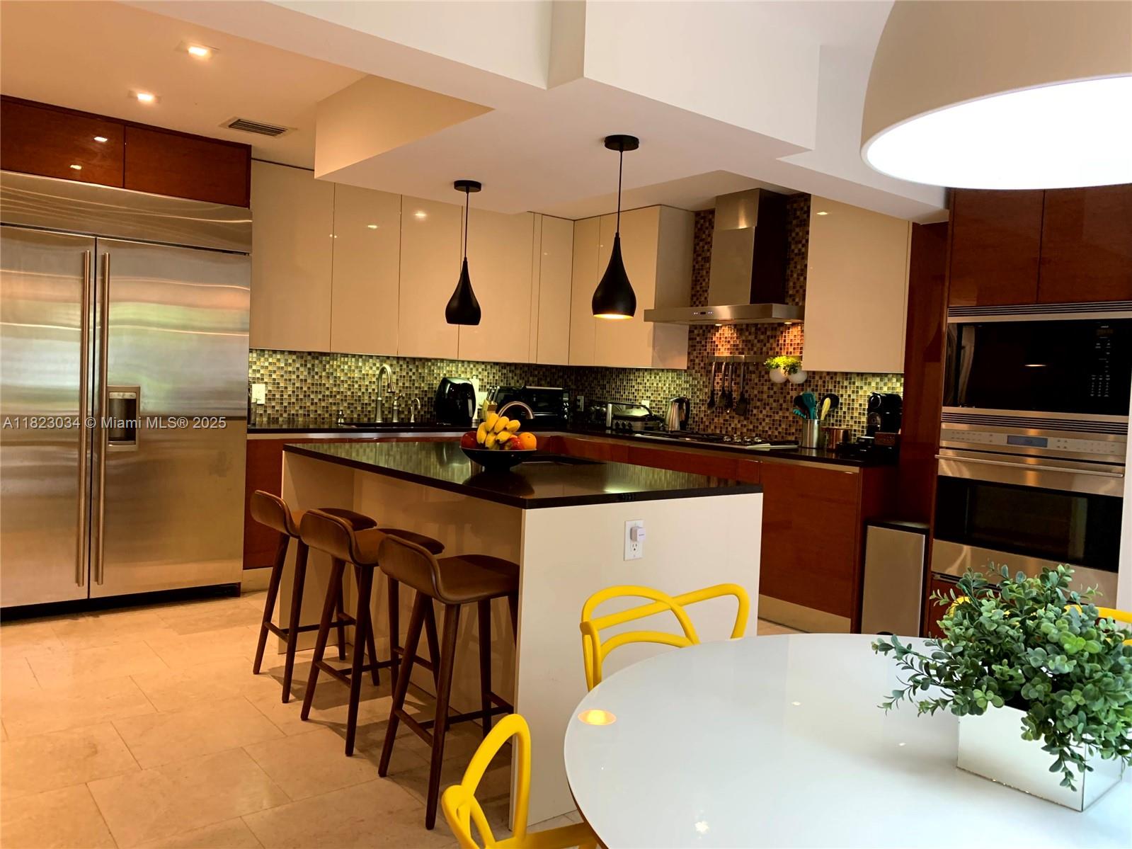 Unique Opportunity! Fully updated 4-bedroom, 3.5-bath modern home in the heart of Hollywood Lakes—just 5 minutes from the iconic Hollywood beach and Broadwalk—This spacious and bright home offers around 3,500 sqft of elegant living with marble floors, a sleek Italian kitchen with Miele, Subzero, and Wolf appliances, spa-like master bath, formal dining and living room, inside laundry, custom his-and-hers closets, high-impact windows, built-in whole-house sound system, and a split floor plan perfect for family life or high-return Airbnb income, all set on the only street in the neighborhood to receive a multimillion-dollar anti-flooding renovation in 2025—on a prestigious Diplomat Parkway corner lot surrounded by $8M+ homes, with the sweetest mangos in town right in your backyard.
