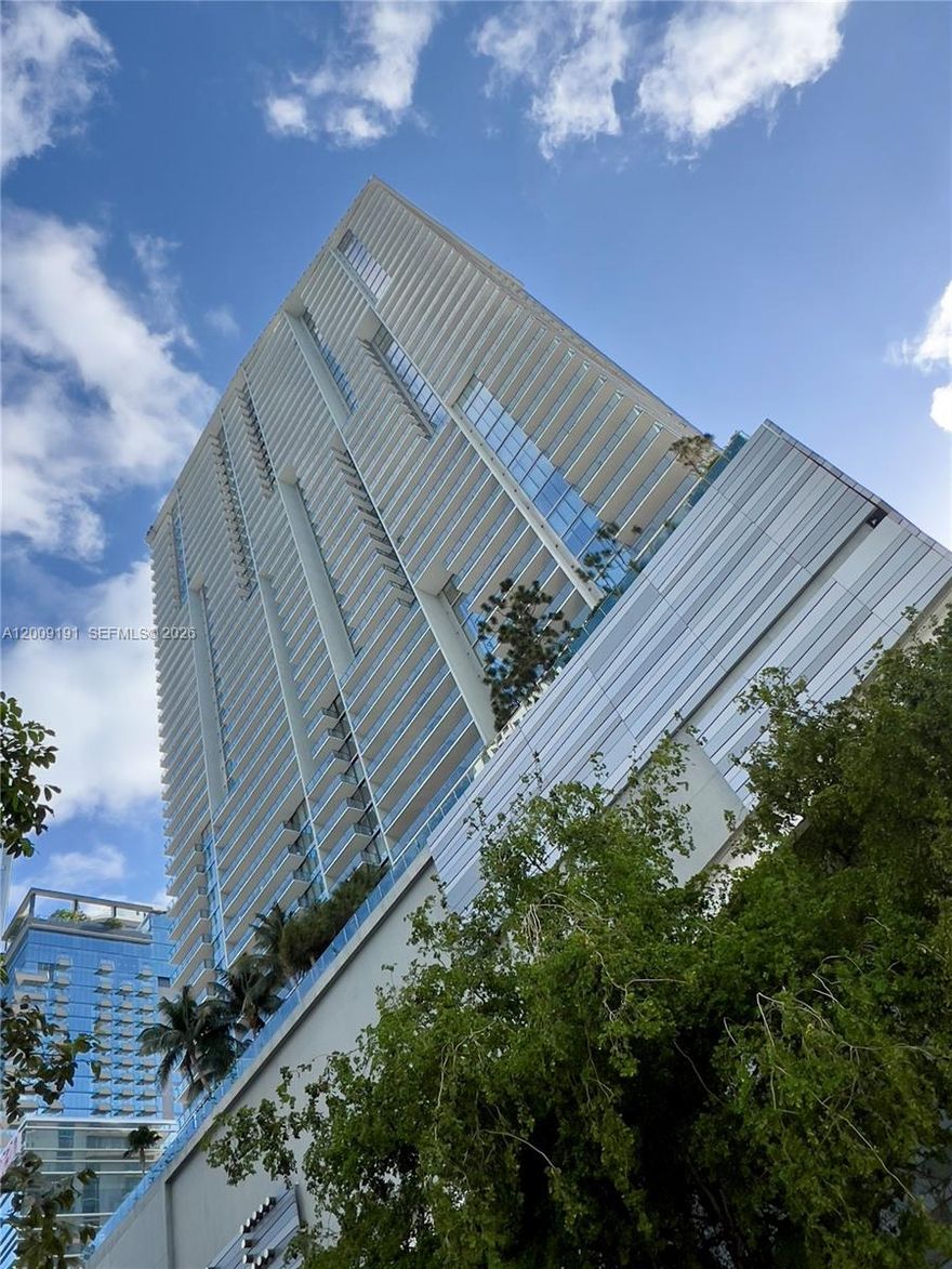 Seller Financing Available. Experience elevated living in this impeccably furnished 1,265 sq ft corner residence at Reach, Brickell City Centre. Designed by one of Miami’s premier interior design firms, this high-floor unit showcases sweeping city views, elegant marble floors, floor-to-ceiling glass, and a spacious wraparound terrace. The modern kitchen features sleek Italkraft cabinetry, premium Bosch appliances, and quartz countertops, blending style and functionality. Residents enjoy world-class amenities including a full-service spa, heated lap and social pools, a state-of-the-art fitness center, and direct access to Brickell’s top-tier shopping and dining.