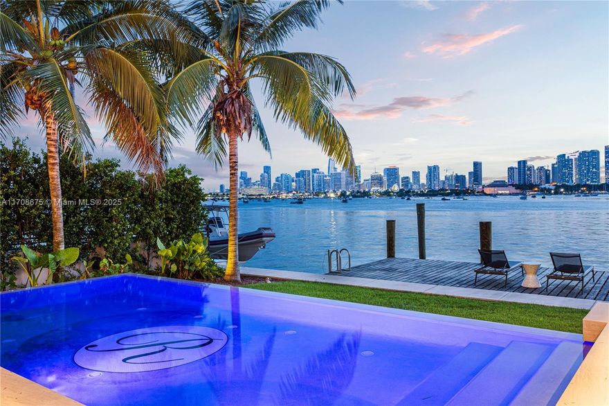 Experience breathtaking sunsets and unparalleled views of the iconic Miami skyline from this exceptional modern waterfront estate, designed by Choeff Levy Fischman. Upon entering, you are greeted by a grand double-height foyer that flows seamlessly into the bright, open-concept living area, complete with sliding telescopic doors for effortless indoor-outdoor living. The expansive primary suite includes a private office with stunning bay views. Featuring exquisite White Oak flooring, rich millwork, and luxurious book-matched marble in both the kitchen and primary bathroom, this home offers a refined blend of elegance and functionality. The property boasts a covered summer kitchen, infinity pool, dock with lift, and a rooftop terrace providing uninterrupted 360-degree views.