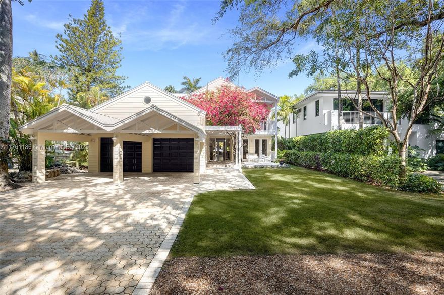 Captivating Key West style home on a coveted tree-canopied street in prestigious North Coconut Grove. Custom built w/ attention to detail and luxury fixtures & finishes throughout. Breathtaking, light-filled living spaces feature soaring, 29-foot+ vaulted, wood-beamed ceilings. Expansive eat-in kitchen & adjacent family room w/ banks of French doors opening to a deep covered terrace. Oversized primary suite is the ultimate retreat & offers private balcony with tree-top views. Experience year-round outdoor living & entertaining around the heated Saltwater pool & sundeck surrounded by lush tropical landscaping. Situated high on a coastal coral rock ridge, one of the highest sea-level elevations in South Florida.