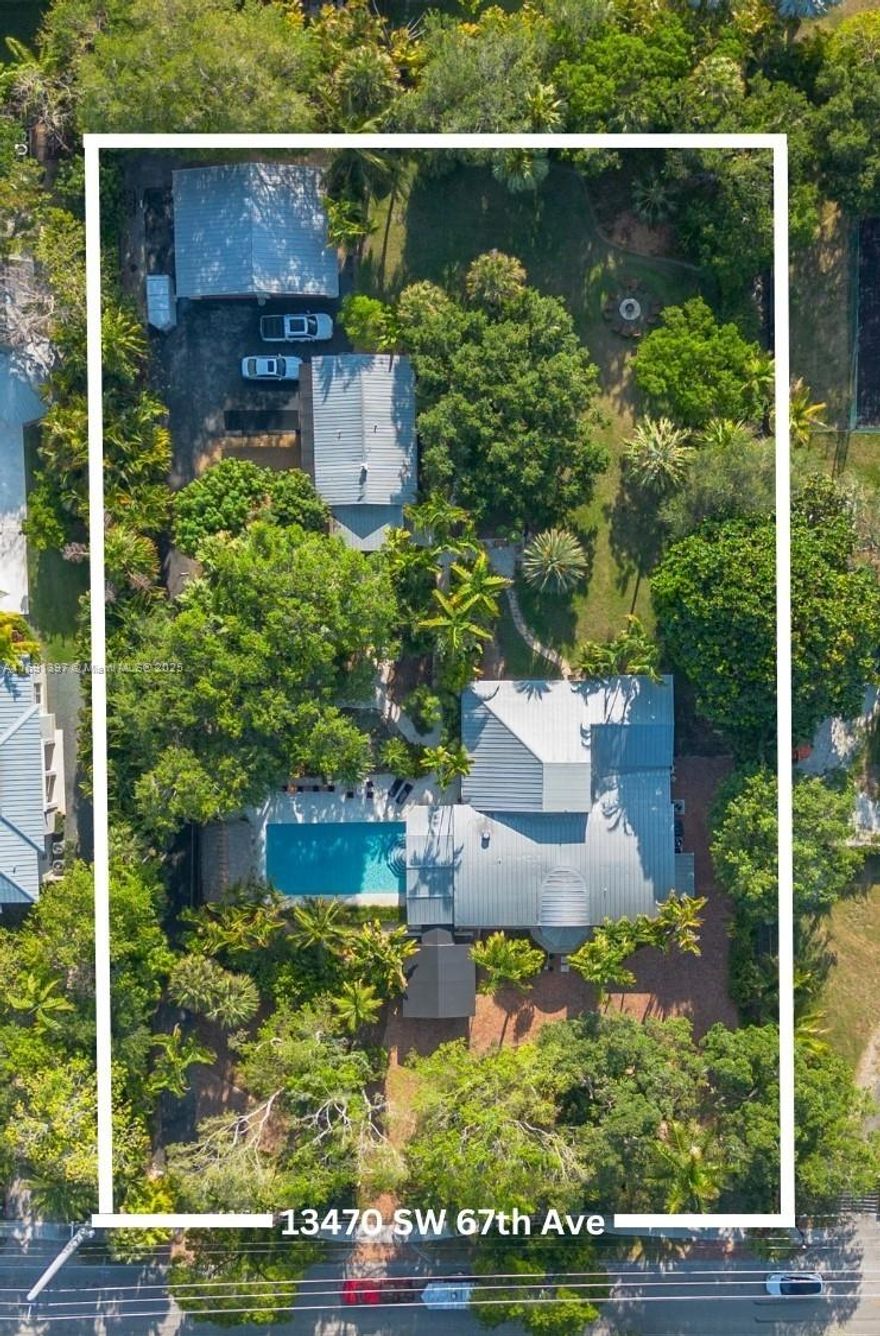This Key West-inspired Pinecrest compound offers a serene retreat on an expansive 1.35-acre property. Thoughtfully designed for both privacy and luxury. Main Residence: Beautifully renovated home with rich wood beams/Bahama shutters. The chef's kitchen is a culinary dream, featuring a gas stove, ample counter space.  Master Suite & Bath: Escape to the luxurious primary suite, complete with a spa-inspired bathroom boasting dual sinks, jet tubs in an inviting bathtub. Thoughtfully designed for ultimate relaxation, this space serves as a personal retreat within the home.  Renovated Cottage: Ideal for guests or as a private studio, the standalone cottage offers a full kitchen and laundry facilities. Four-Car Garage: An air-conditioned 1,200 sq ft garage for 4 cars, perfect for car enthusiasts!