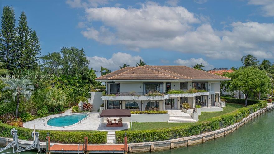 Spectacular contemporary estate set on a coveted cul-de-sac along Cape Florida Dr., one of Key Biscayne’s most prestigious and private addresses. Situated on a 23,724 sqft lot with +250 ft of waterfront and elevation of 8.71 ft above sea level, this home offers 8 bedrooms (including a guest suite and 2 staff quarters), 8.5 baths, a private dock, boat lift, and resort-style pool. A grand foyer with soaring ceilings introduces an architectural masterpiece designed by renowned architects and built by Interscope. More features include an elevator, full-home generator, reinforced concrete seawall, 2-car garage + porte-cochere for 4 cars, and driveway for 8+ cars. Discover the exceptional potential of this unique estate—a perfect blend of elegance, privacy, and premier waterfront living.