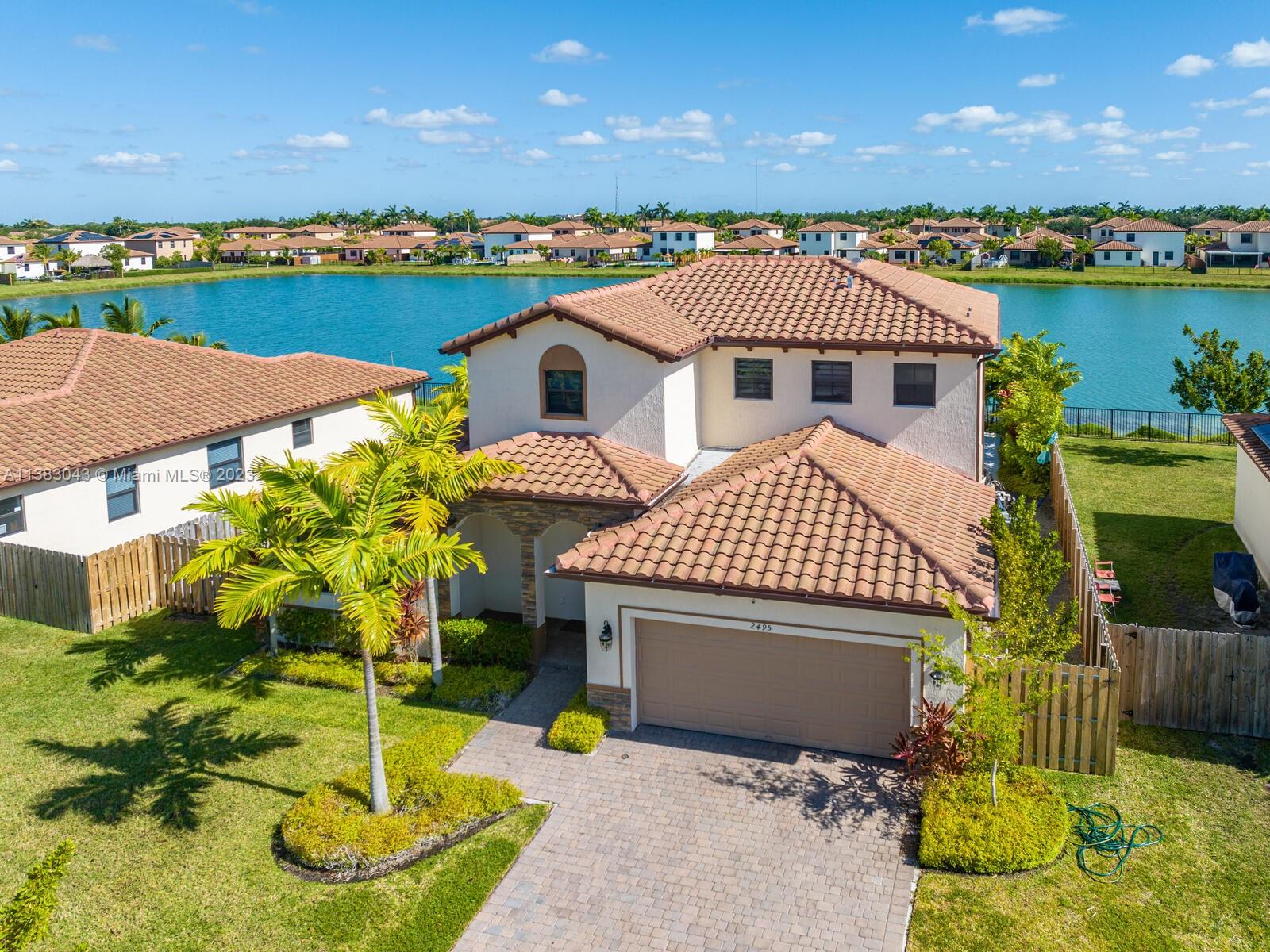 Elegant, two-story with 2 car garage in upscale Portovita community, with completely new saltwater conversion pool system, three bedrooms upstairs 2 full bathrooms, and one bedroom downstairs with a large loft or office and one full bathroom and a guest bathroom, hurricane shutters, landscape, right on the lake with large, fenced backyard. An absolute dream to show. Ready for a family to move in. Walking distance to the community center with an exercise room, pool, children's playgrounds, and much more, close to the Florida Keys, marina, restaurants, and supermarkets.