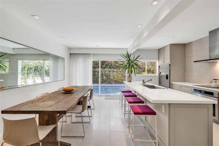 Pool home RETREAT!  Experience living in TRUE MIAMI Mid-Century MODERN architecture! Classic terrazzo floors.  Abounding in natural light & vaulted high ceilings with tall clerestory windows...this home has a "GREAT VIBE" and you feel it the minute you walk in!  The entire house has been remodeled from top to bottom! Gorgeous large new kitchen overlooks the swimming pool and spacious dining room.  Lots of oversized impact windows with a comfortable living room. Both bedrooms are roomy, and the Primary bedroom has a new bathroom ensuite and a walk-in closet. * Additional space offers an extra 'office' room or TV nook. The full 1-car garage with finished ceiling also offers a new laundry area and additional closet space.
