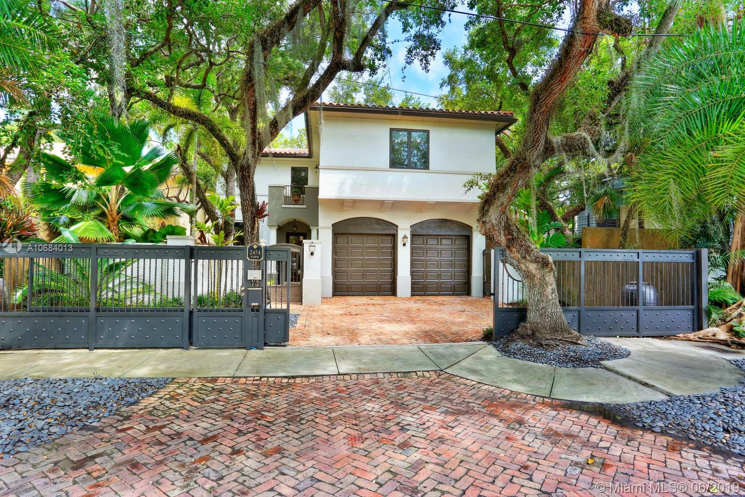 Ultra-private, walled & gated villa in prestigious North Coconut Grove. Walk to bayfront parks, marinas  & to the Grove village. Located at one of the highest sea-level elevations in S.Florida. Stunning, light-filled interior spaces offer double-height ceilings, stone & hardwood flooring and a blending of classic architectural details w/a modern vibe. Expansive formal living, dining & family rooms. Spectacular custom kitchen features wood cabinetry, quartz countertops, center island & an adjacent breakfast area. Luxurious master suite includes an alcove sitting area, separate office, private balcony & stunning bath featuring soaking tub & frameless glass shower. Emergency generator connected to city gas. Lush interior courtyard + separate covered terrace overlooking the tranquil pool & spa
