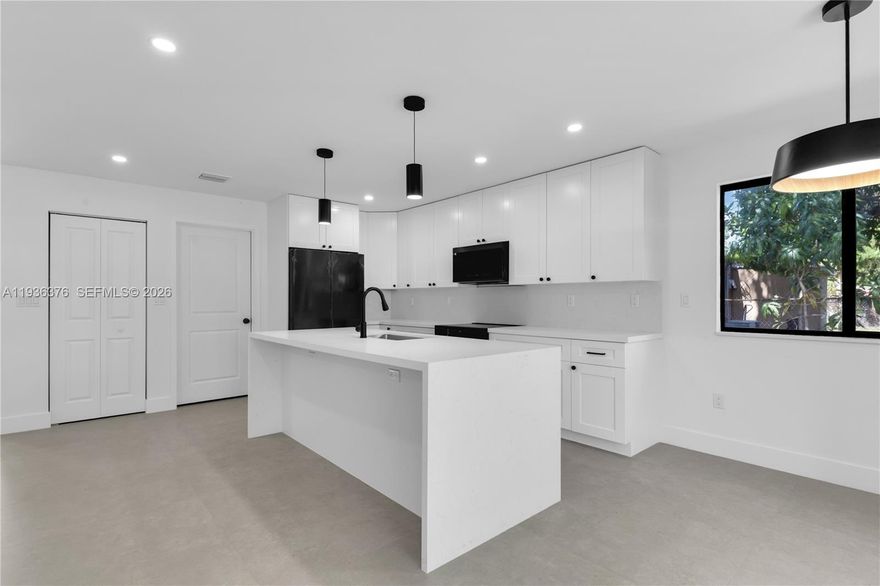 Brand-new construction 2025 4 bedroom/ 3 bath South Miami home walking distance to the University of Miami and situated within the Sunset Elementary School boundaries. This beautiful residence features a bright open-concept layout with porcelain tile flooring throughout, the home offers modern elegance and functional living. The designer kitchen showcases quartz countertops custom cabinetry, a large waterfall-edge island, sleek black fixtures, and stylish pendant lighting. Recessed LED lighting throughout enhances the clean contemporary feel.  Additional features include impact windows and doors, spacious bedrooms, custom closets and beautifully designed bathrooms. A rare opportunity to own new construction in this rapidly transforming area.