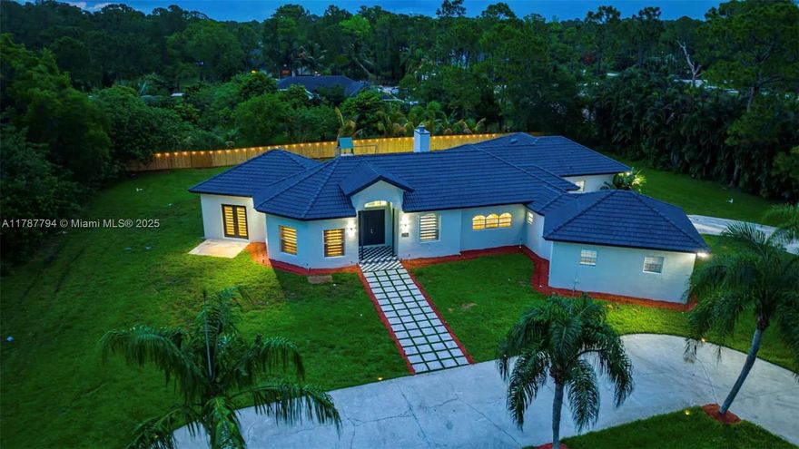 Nestled on 1.19 acres in the serene Loxahatchee area, this Mediterranean-inspired estate offers 6 bedrooms and 4 bathrooms across 3,259 sq ft. Built in 2003, the home features an open-concept layout with a gourmet kitchen, stone columns, and tall ceilings. The entryway leads directly to an 18x36 in-ground pool, ideal for entertaining or relaxing. Additional amenities include walk-in closets, a game room, and a spacious backyard. Located near dining, shopping, and the beach, this property offers the ideal coastal retreat.