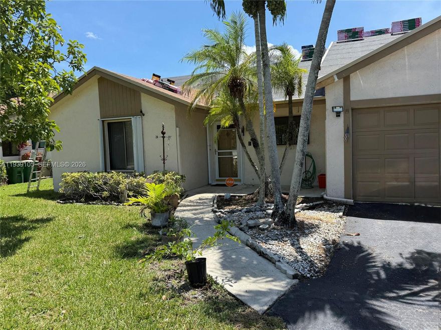 ALL AGE  Quietcommunity waterfront oasis in Tamarac's Edgewater neighborhood! This turnkey villa with a split floor plan the waterfront windows and a garage. This beautiful home is a 2/2 1332 Sq Ft. easily add a 3rd bedroom or office in the living space owner will to do. A BRAND NEW roof 8/2025.  single car garage, hurricane shutters, & screened in Patio with an insuated roof.  Inside boasts, an open-concept design, vaulted ceilings, new Luxury Vinal flooring, a remodeled kitchen with granit countertops, updated modern bathrooms. Clubhouse with a community pool and close to shopping, dining, and entertainment. Low HOA fee covers lawn care.