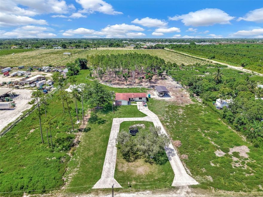 Experience the perfect blend of modern living and peaceful country charm in this beautifully remodeled 4 bedroom, 2 bathroom home on nearly 5 acres in Homestead. This move-in-ready property features an open concept layout with spacious living area, updated kitchen with marble countertops, stainless steel appliances, Bar area and custom cabinetry. Modern Bathrooms, new flooring throughout, impact windows and doors. Enjoy privacy, space and versatility. Ideal for farming, livestock, or future expansion. The land offers ample room for a guest house, pool, workshop or recreational use. Conveniently located near Krome Ave, US-1, and the Redland Area. Contact us today for more information and a property tour.