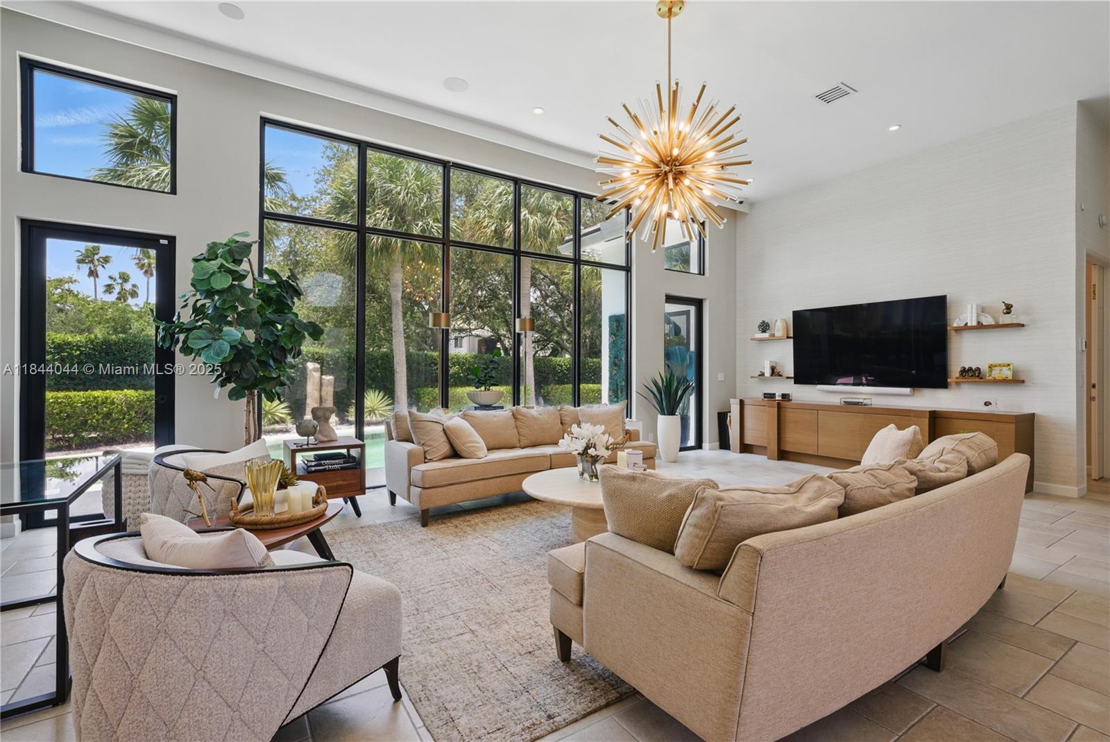 This beautifully updated 3 bed/3 bath residence offers a tranquil, resort-like setting within Boca Estates. Step inside to soaring 13-foot ceilings and expansive floor-to-ceiling windows that flood the space with natural light. A chef’s kitchen showcases premium appliances including Sub-Zero, Dacor, Miele, and a Zephyr dual-zone wine fridge, along with quartz countertops, a walk-in pantry, and a custom built-in bar. The home features two primary suites plus a versatile third bedroom. The private backyard retreat includes a covered patio, heated saltwater pool, tranquil water feature, turfed yard, lush landscaping, and an outdoor shower. Additional highlights include Lutron lighting, Sonos audio, a whole-house water filtration system, and a full backup generator.
