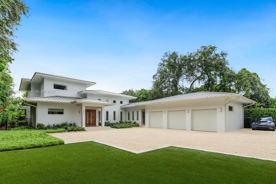 Modern luxury living at its best. Built in 2015 with exceptional attention to detail. Designed around dramatic 16' ceiling great room and Porcelanosa kitchen with 15' Krion waterfall island, top of the line appliances from Wolf Miele and Subzero. Excellent floor plan including downstairs master suite. Five-bedroom layout with den/gym that could easily work as sixth bedroom. Covered terrace with motorized mosquito screen, beautiful pool, large private back yard, summer kitchen and 3-car garage. Visser custom built closets and Sonos music system throughout. Set back in gated deep 28,314 sq ft lot with mature trees. This custom green home was built to LEED Silver certification standards. Full house generator. Great location – close to everything.