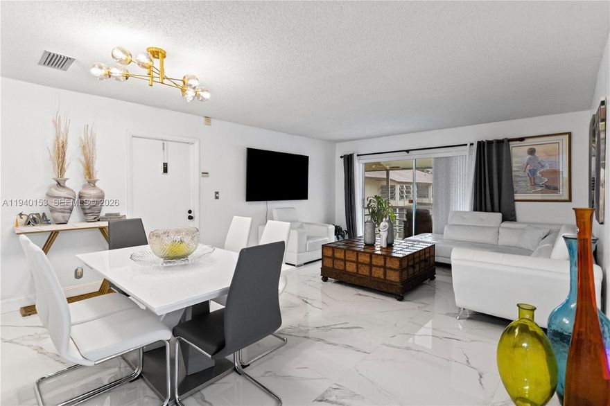 This spacious second-floor condo truly has it all. Thoughtfully designed and beautifully updated, it features elegant large-format porcelain flooring throughout and a stunning, modern white kitchen with quartz countertops—perfect for even the most discerning chef. The bathrooms are comfortable and well appointed, and the walk-in closets are a wonderful feature that add everyday convenience. Enjoy a screened and tiled porch, ideal for relaxing mornings or unwinding in the evening.This unit offers true peace of mind with a new roof, reserves in place, and association insurance and reserve funds fully funded. The parking lots are scheduled to be repaved, already included in the association’s budget—no special assessments planned.

Financing is flexible, with FHA, VA, and conventional loans welcome, making this an excellent opportunity whether you’re a first-time buyer or looking to downsize in comfort. Just 3 minutes to the Turnpike and SR-441, with shopping, Walmart, restaurants, and hospitals within walking distance, and Pompano Beach only a 12-minute drive.

Located in The Laurels at Margate, a lush and well-maintained community surrounded by mature trees, offering a peaceful setting perfect for walking and enjoying the outdoors, while still being close to everything you need. This is one of the nicest units in the complex, ready for you to enjoy—worry free.