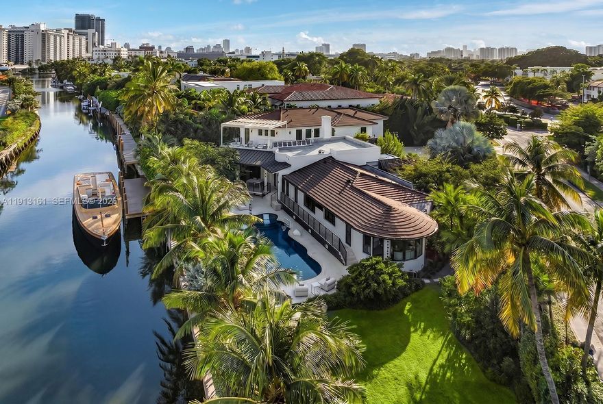 Located just moments from the beach & boardwalk, this contemporary waterfront oasis offers utmost resort style living.  Enjoy refined coastal living on an oversized 25,850 SF lot with 237 FT of waterfrontage. The open chef’s kitchen boasts marble book-matched countertops, handcrafted tiles & full prep pantry. This estate is ideal for entertaining w/ expansive open living areas, 150 sf wine cellar, sprawling circular driveway, a 47-foot heated saltwater pool, summer kitchen & lush tropical landscaping. This home features 2 luxurious primary suites, gym, 2 car garage & Control 4 system. Private roof deck awaits w/ beautiful water views & summer kitchen w/grill. Enjoy tranquil luxury living just a short walk from Miami Beach’s top restaurants & beach clubs!