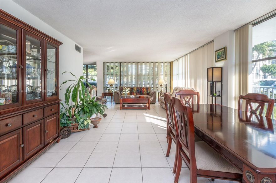 Bright and airy corner unit on the first floor with a wrap-around porch! This 3 bedroom, 2 bath condo features floor-to-ceiling windows that flood the space with natural light. *The third bedroom has been opened to offer more space to the living room.* The building has passed its 40 year inspection. Enjoy resort-style amenities, including a large pool, sauna, two gyms, two tennis courts, security, front desk service, billiards, ping pong, a clubhouse, BBQ area, guest parking, and more. Ideally located just a short drive to the beach, major highways, restaurants, entertainment, and international airports.