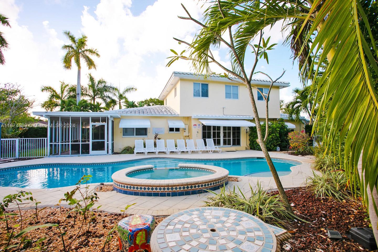 Fabulous house on a double corner lot in the highly desirable Hollywood Lakes area, just minutes from the beach. This beautifully upgraded 6 bedroom / 3 bath home features a newer second floor, high-impact doors and windows, a stunning backyard with a large pool perfect for entertaining, six bedrooms, three bathrooms, and a gorgeous Florida room. The first floor retains its original terrazzo flooring, while the second floor showcases elegant hardwood floors. The open kitchen flows seamlessly into the living and dining areas. Conveniently located near downtown Hollywood, Gulfstream, Aventura Mall, Hard Rock Casino, restaurants, and much more.