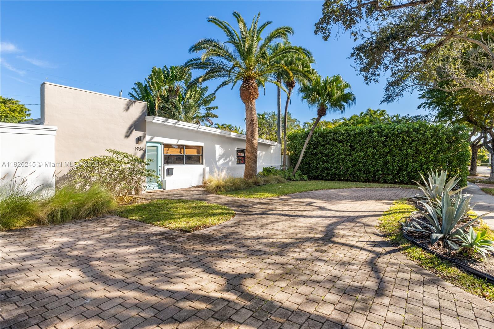 Located in the gated community of Keystone Point, this updated mid-century modern home offers the perfect mix of comfort, light, and character just minutes from Aventura and Bal Harbour. The spacious interior features an open layout, filled with natural light, and a rare double-island kitchen with modern appliances—ideal for cooking, hosting, or casual dining. A glass-enclosed great room creates a bright, airy space perfect for relaxing or entertaining. The garage has been thoughtfully converted into a versatile third bedroom or home office. Step outside to a private, lushly landscaped backyard surrounded by mature hedges, offering a tranquil outdoor retreat in one of Miami’s most desirable neighborhoods.