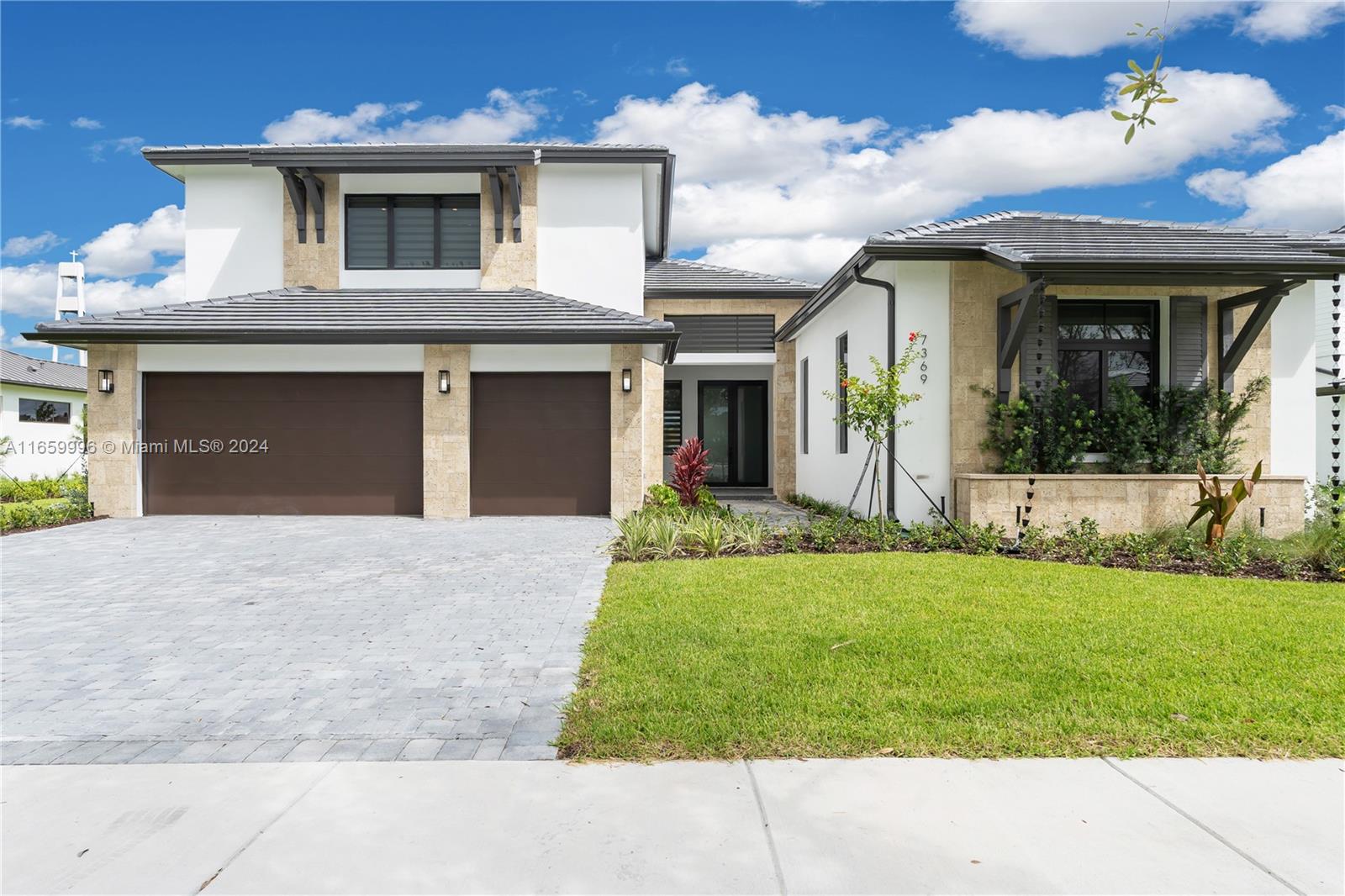 Introducing this brand-new home in the exclusive Pine Rockland Estates, a private community of only 26 residences. Set on a 15,018 sq. ft. lot, 5-bedrooms, 6.5-baths, this home is move-in ready with a stunning design. Inside, the home showcases designer porcelain tile floors and a state of the art A/C. Expansive impact windows/doors flood the home with natural light. The custom ItalKraft kitchen features JENNAIR appliances and sleek quartz counters/backsplash. The master suite offers two large walk-in closets and a spa-like soaking tub, glass-enclosed shower, dual vanities, and designer fixtures. The loft is complete with a built in wet bar/mini fridge, perfect for entertaining. The "casita" is essentially two rooms in one with mini-fridge and a separate entrance. Actual 5,406 sq. ft.